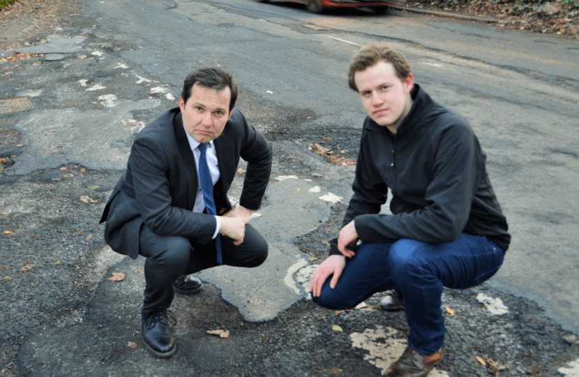 Chris with a local resident near potholes