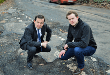 Chris with a local resident near potholes